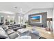 Bright living room features vaulted ceilings, sleek furniture, and modern gray and white decor at 5285 Far Oak Cir, Sarasota, FL 34238