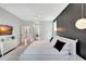 Spacious main bedroom features modern decor, an accent wall, and large windows to pool area at 5285 Far Oak Cir, Sarasota, FL 34238
