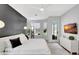 Sunlit main bedroom features an accent wall, large windows, and modern minimalist decor at 5285 Far Oak Cir, Sarasota, FL 34238