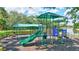 A community playground overlooks a tranquil pond creating a serene play environment at 5285 Far Oak Cir, Sarasota, FL 34238