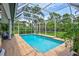 A beautiful in-ground swimming pool is surrounded by a screened enclosure and wooden deck at 5285 Far Oak Cir, Sarasota, FL 34238