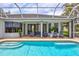 Relaxing pool area with outdoor seating and plenty of shade from screened enclosure at 5285 Far Oak Cir, Sarasota, FL 34238