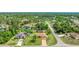 Aerial view of a cozy home nestled among lush greenery and mature trees in a quiet neighborhood at 5307 Kenvil Dr, North Port, FL 34288