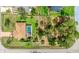 Overhead view showcasing a home with a private pool, fenced backyard, and mature landscaping at 5307 Kenvil Dr, North Port, FL 34288