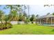 A well-maintained backyard with a screened-in pool area, storage shed, and white vinyl fence at 5307 Kenvil Dr, North Port, FL 34288