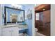Bright bathroom features a large mirror, updated sink, vanity, and a step-in shower at 5307 Kenvil Dr, North Port, FL 34288