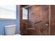 Updated bathroom with a step in shower featuring a glass enclosure and tile walls at 5307 Kenvil Dr, North Port, FL 34288