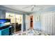 Bedroom featuring a ceiling fan, sliding glass doors, and spacious closet at 5307 Kenvil Dr, North Port, FL 34288