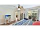 Bedroom features wood floors, a ceiling fan, and access to the outdoor patio at 5307 Kenvil Dr, North Port, FL 34288