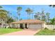 Attractive single-story home featuring a well-manicured lawn, palm tree, and attached two-car garage at 5307 Kenvil Dr, North Port, FL 34288