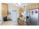 Updated kitchen featuring stainless steel appliances, wooden cabinets and stone countertops at 5307 Kenvil Dr, North Port, FL 34288