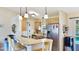 Bright kitchen features wooden cabinetry, stone countertops, and stainless steel appliances at 5307 Kenvil Dr, North Port, FL 34288