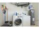 Functional laundry room with washer, dryer, and water heater at 5307 Kenvil Dr, North Port, FL 34288