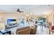Spacious living room with a kitchen view, modern appliances, comfortable seating and ample lighting at 5307 Kenvil Dr, North Port, FL 34288