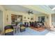 A beautiful covered patio with a ceiling fan, nice furniture, and an opening to the pool area at 5307 Kenvil Dr, North Port, FL 34288