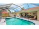 Inviting screened-in pool with covered patio and well-maintained deck at 5307 Kenvil Dr, North Port, FL 34288