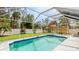 Relaxing screened-in pool area with ample seating and lush landscaping at 5307 Kenvil Dr, North Port, FL 34288