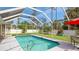Relaxing screened-in pool area with ample seating and lush landscaping at 5307 Kenvil Dr, North Port, FL 34288