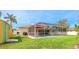 A lovely backyard featuring a screened-in pool, a grill, and a colorful storage shed at 5307 Kenvil Dr, North Port, FL 34288