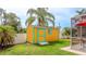 The backyard features a colorful shed and a screened-in pool area at 5307 Kenvil Dr, North Port, FL 34288