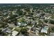 Aerial view showcasing a residential neighborhood with a mix of homes, mature trees, and community parks at 5412 Skyline Pl, Sarasota, FL 34232