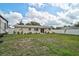 Large backyard featuring a well-maintained lawn, white fence, and patio area at 5412 Skyline Pl, Sarasota, FL 34232