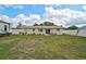 Spacious backyard with well-kept lawn, white fencing, and a charming patio seating area at 5412 Skyline Pl, Sarasota, FL 34232