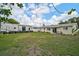 Expansive backyard featuring a well-maintained lawn, recreational vehicle, and access to the home's sliding glass doors at 5412 Skyline Pl, Sarasota, FL 34232