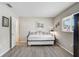 Cozy bedroom featuring neutral tones, laminate flooring, and natural light from a window at 5412 Skyline Pl, Sarasota, FL 34232
