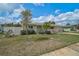 Lovely single-story home with charming landscaping, a bright blue front door, and a well-kept lawn at 5412 Skyline Pl, Sarasota, FL 34232