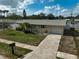 Charming home with a well-kept lawn, an inviting blue door, and a driveway leading to an attached garage at 5412 Skyline Pl, Sarasota, FL 34232