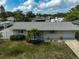Inviting home with a lush front yard, vibrant flowers, and a well-maintained facade at 5412 Skyline Pl, Sarasota, FL 34232