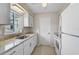 Bright kitchen with stone countertops, all white appliances and sleek modern hardware at 5412 Skyline Pl, Sarasota, FL 34232
