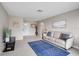 Bright living room featuring neutral paint, comfortable seating, and a decorative blue area rug at 5412 Skyline Pl, Sarasota, FL 34232