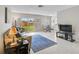Comfortable living room featuring neutral colors, plush seating, and sliding glass doors to the yard at 5412 Skyline Pl, Sarasota, FL 34232