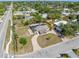 Aerial view of a single story home showing roof damage, surrounding neighborhood and nearby roadways at 5705 23Rd W St, Bradenton, FL 34207