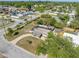 Aerial view of a damaged home within a neighborhood setting, highlighting street access and surrounding landscape at 5705 23Rd W St, Bradenton, FL 34207