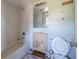 Bathroom view of a white tub, toilet and large mirror with missing wall tiles at 5705 23Rd W St, Bradenton, FL 34207