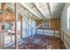 Bare bedroom shows the rafters and studs and the door to the exterior of the home at 5705 23Rd W St, Bradenton, FL 34207