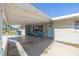 A very large carport with an entrance door and with chairs on the front porch at 5705 23Rd W St, Bradenton, FL 34207