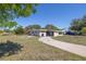 Modest single-story home with overgrown landscaping and a curved driveway at 5705 23Rd W St, Bradenton, FL 34207
