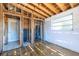 Renovation opportunity: interior with exposed wooden framework and studs alongside damaged walls and flooring at 5705 23Rd W St, Bradenton, FL 34207