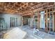 Living room with exposed studs and ceiling, showing the layout of an older home under renovation at 5705 23Rd W St, Bradenton, FL 34207