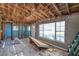 Living room with exposed rafters showing a window, a doorway, and gray painted walls at 5705 23Rd W St, Bradenton, FL 34207