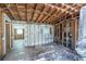 Exposed studs and walls of living room shows a doorway to another room at 5705 23Rd W St, Bradenton, FL 34207