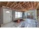 Living room with exposed rafters and wall studs showing a window and door at 5705 23Rd W St, Bradenton, FL 34207