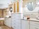 Bathroom featuring dual vanities, designer mirrors, and custom tiled backsplash at 5880 Midnight Pass Rd # 207, Sarasota, FL 34242