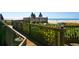 Wooden walkway to beautiful beach with white sands and umbrellas at 5880 Midnight Pass Rd # 207, Sarasota, FL 34242