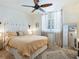 Bedroom featuring neutral tones, a ceiling fan, and plantation shutters at 5880 Midnight Pass Rd # 207, Sarasota, FL 34242