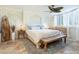 Beautiful bedroom featuring neutral tones, wood accents, and a decorative ceiling fan at 5880 Midnight Pass Rd # 207, Sarasota, FL 34242